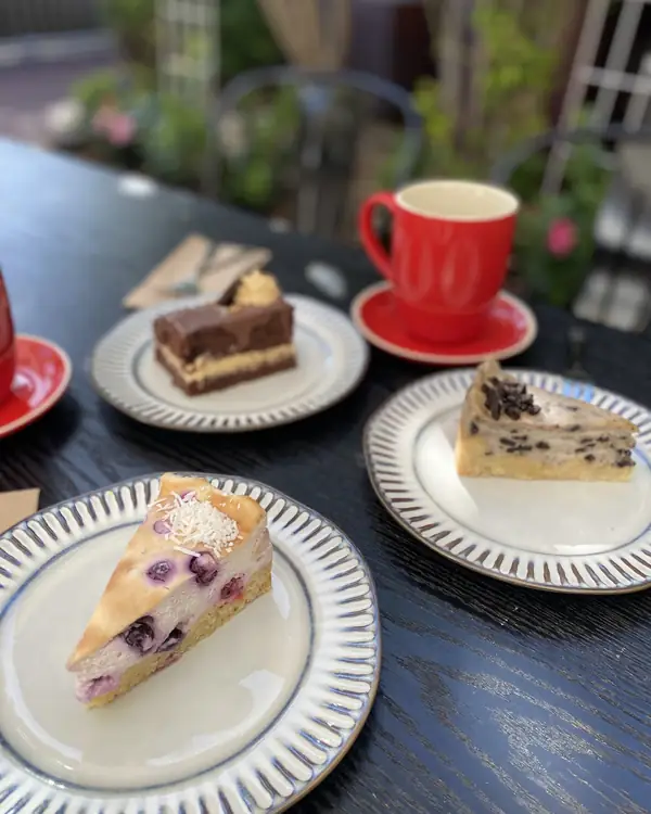 Vegan cakes and a coffee on the courtyard table